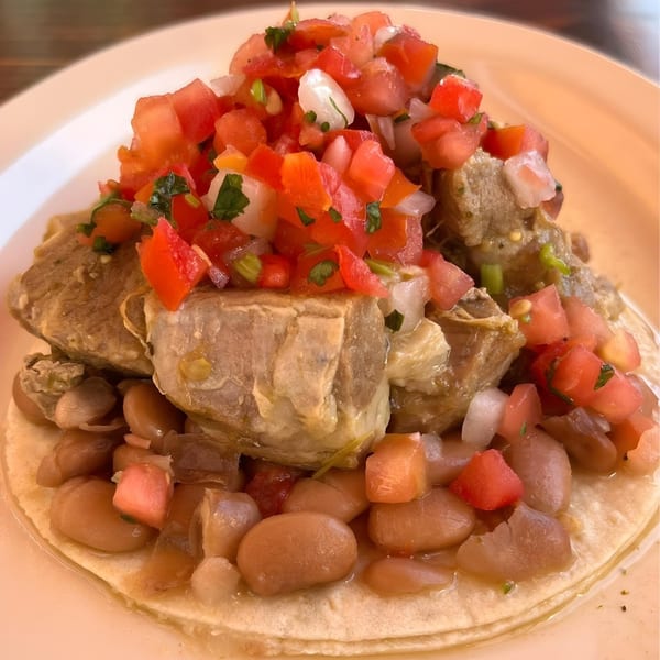 La Corneta Taqueria's Mexican taco with meat, beans, and fresh pico de gallo.